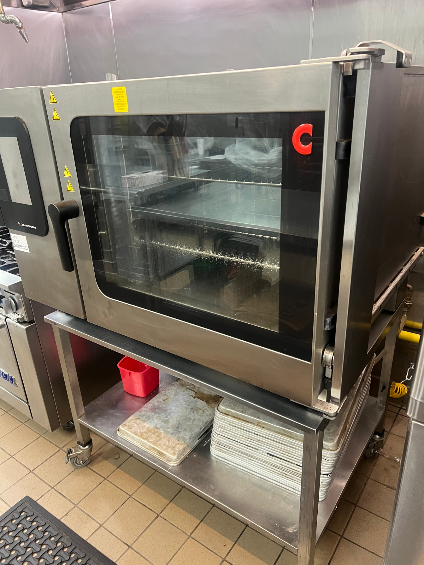 Combi oven steamer on a stainless equipment stand after detailing